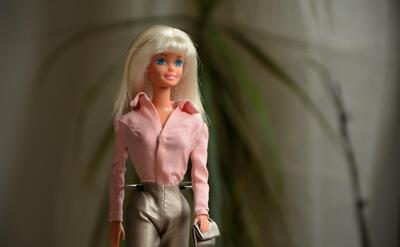 A classic Barbie doll with pink dress.