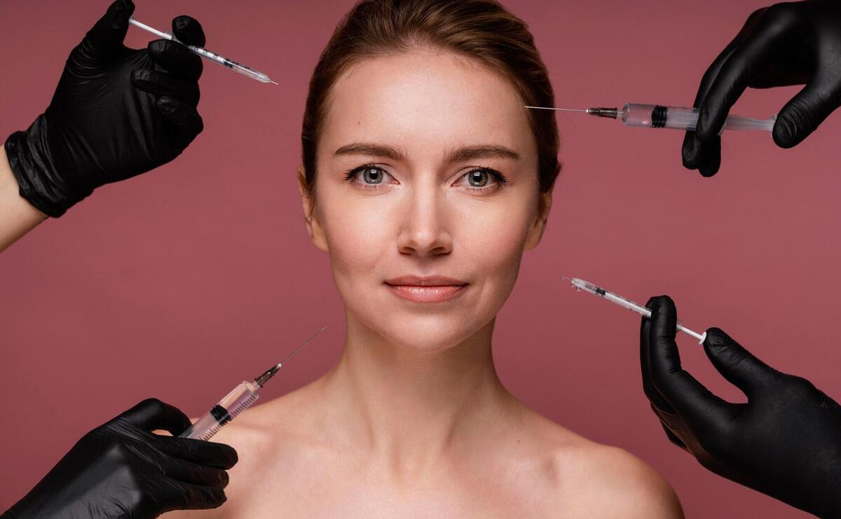 Beautiful woman having her face injected.