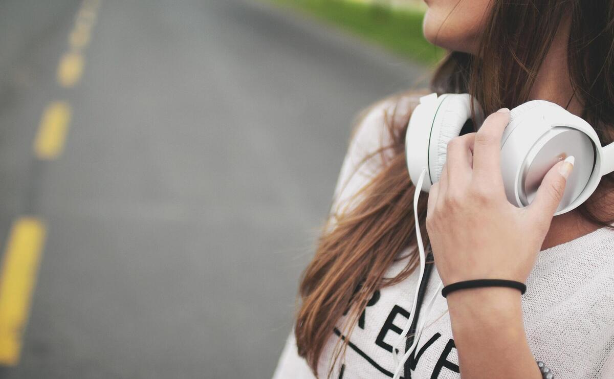 A girl with white headphones.