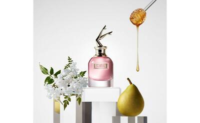 Parfume surrounded with pears.