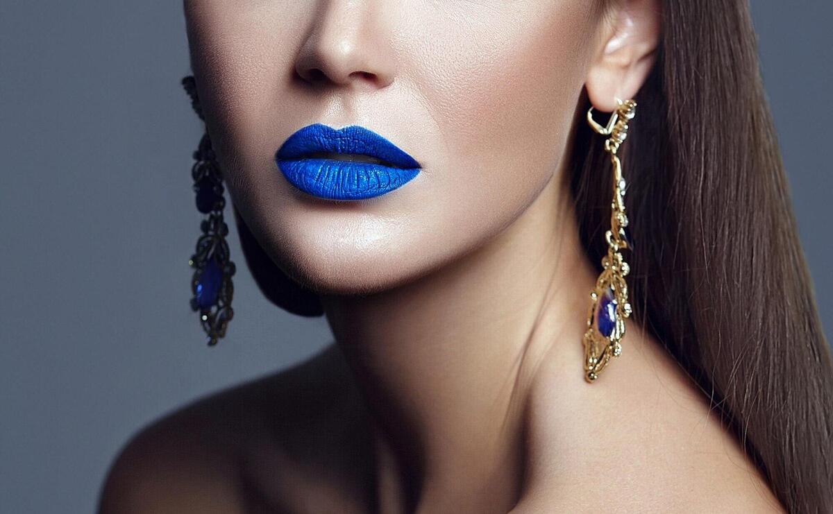 Beautiful woman lady with blue lips and jewelry