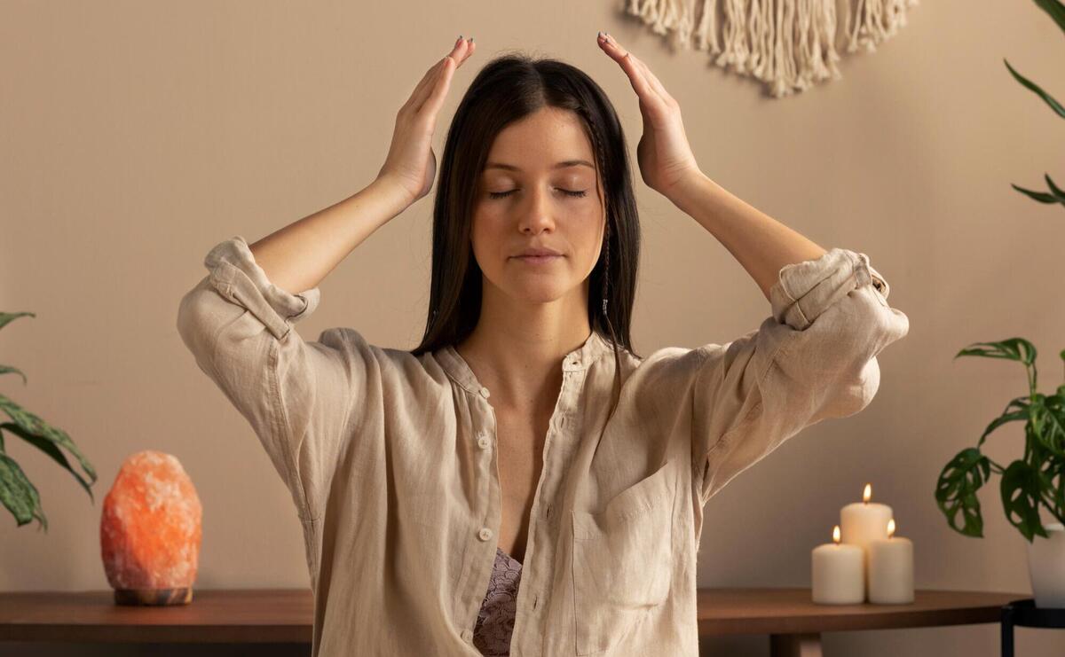 Person conducting reiki therapy.