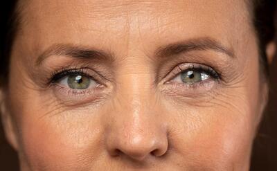 Close-up of mature woman's eyes, revealing depth and emotion.