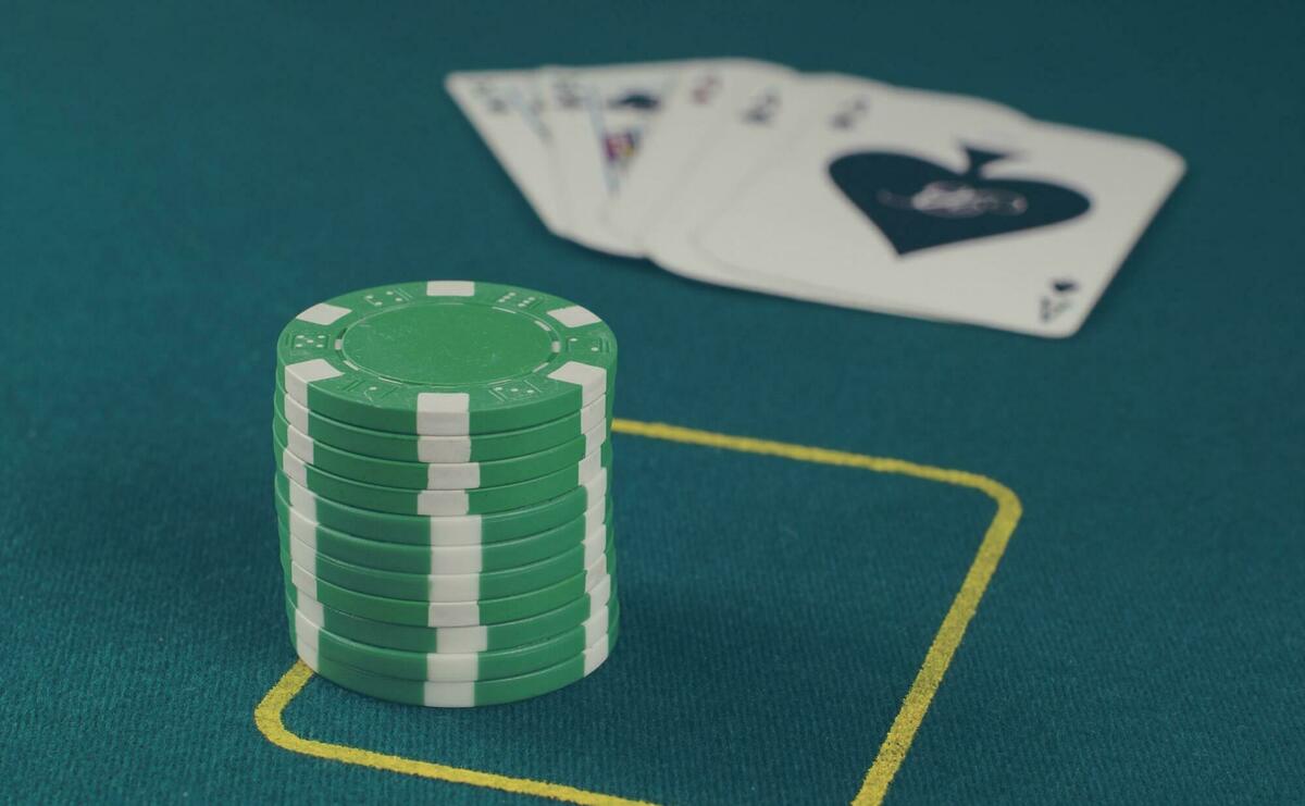 Green poker chips on table