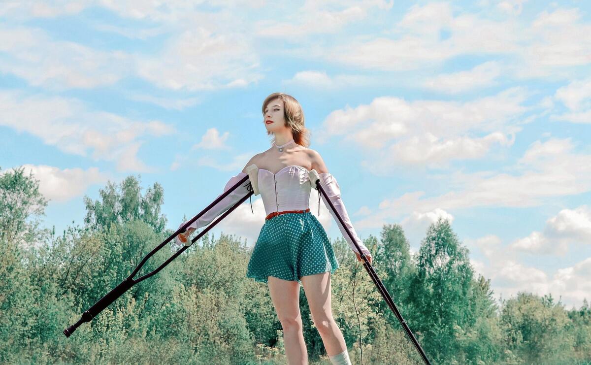 Girl walking with walking sticks.