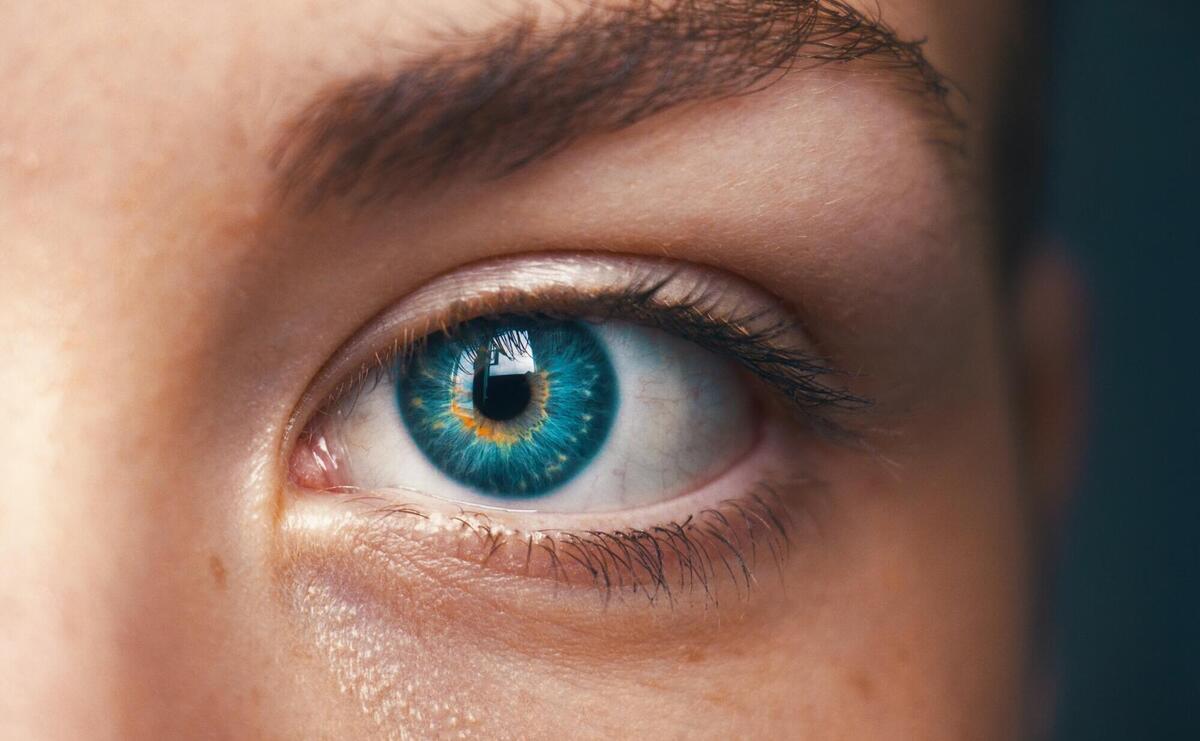 Close-up of a striking blue human eye.