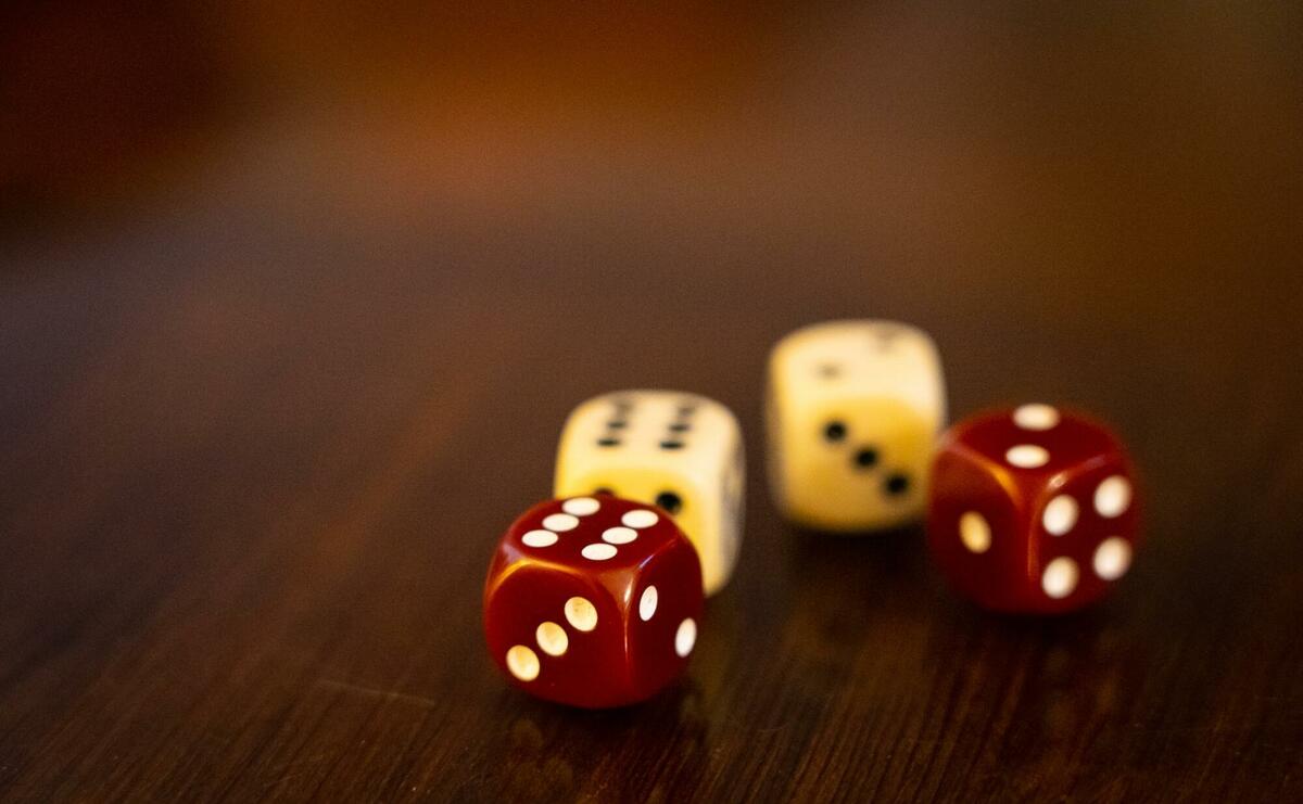 Four playing dies on a table.