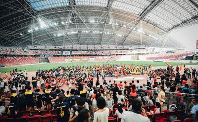 A crowd in a football field in Singapore.
